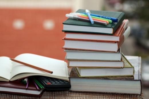 A stack of books with pencils