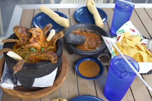 The molcajete mar y tierra served with chips, bean dip and salsa made on table. (Elle Bent/Community Impact)