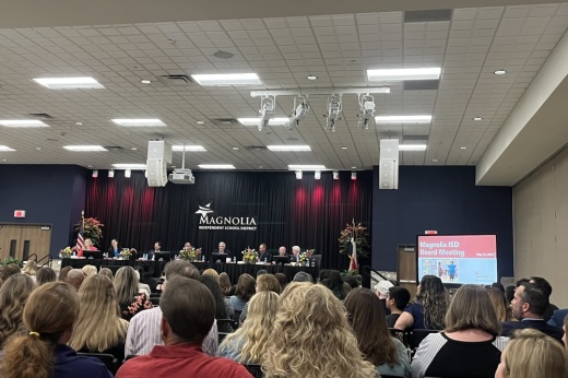 people sit and watch the magnolia isd board of trustees