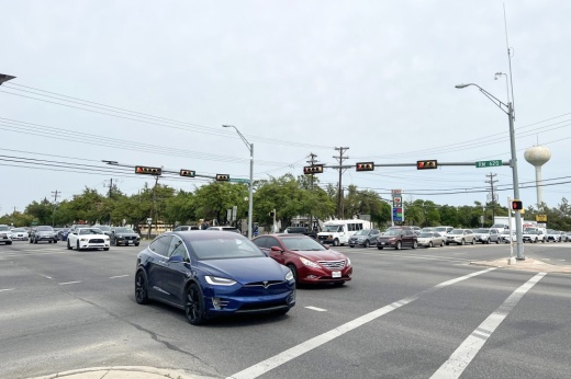 Cars driving through street intersection