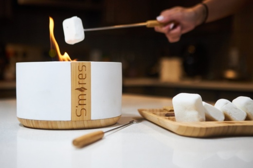 a person roasting a marshmallow over fire