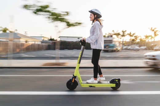 Woman riding an electric scooter on the street