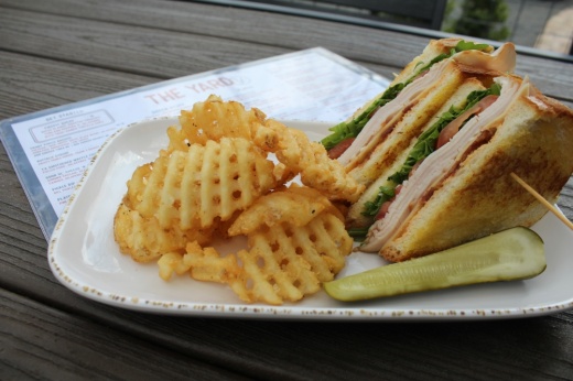 sandwich and fries on a plate with pickles