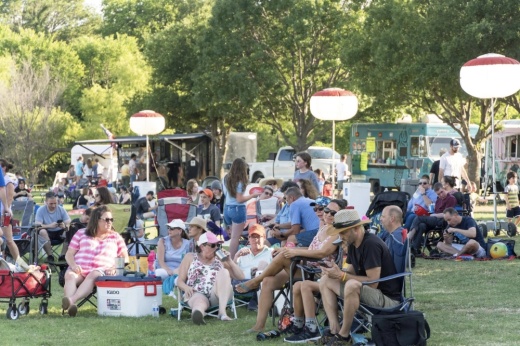Festival-goers sitting in lawn chairs