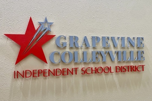 a sign on a wall that has a star and says Grapevine Colleyville Independent School District