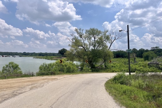 a small road next to a lake