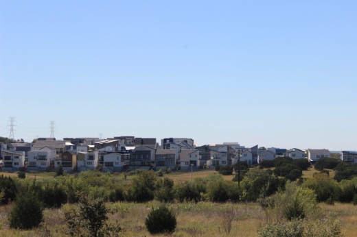 outdoor view of townhomes in the distance with trees