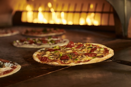 Pizzas in front of the oven