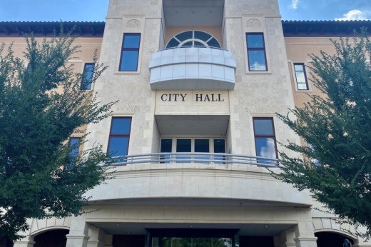 a three-story building that says city hall on it