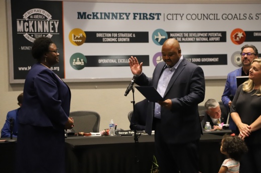 Michael Jones being sworn in by City Secretary Empress Drane at a council meeting