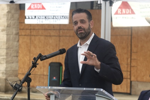 Adam McGough speaking at a podium