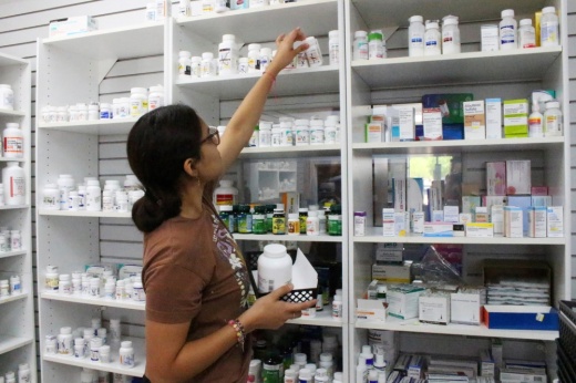 At Greenpath Pharmacy, located on Hwy. 59 in Kingwood, pharmacy technician Cecilia Noyola stocks medications. The pharmacy is one of thousands of pharmacies nationwide struggling with ongoing drug shortages. (Emily Lincke/Community Impact)