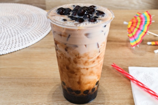 Milk tea with boba in a clear cup on a table