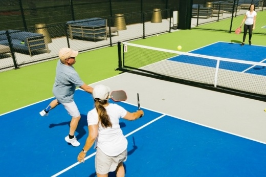 A man and woman playing pickleball