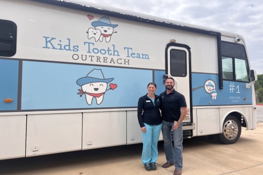 Alex, left, and Tim Otto stand in front of the mobile dental clinic