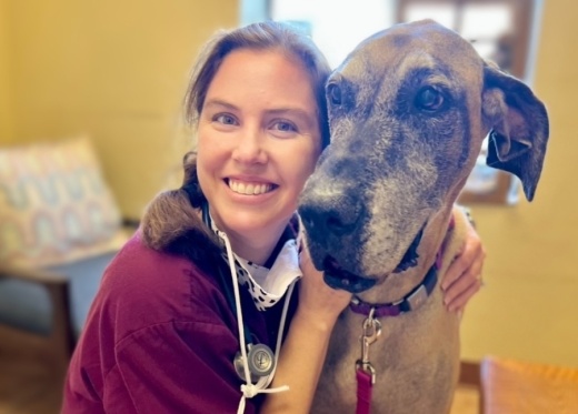 person poses with a dog