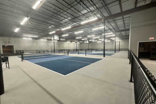 The interior of a pickleball facility, which includes several courts.