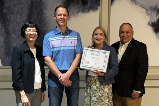 Four League City staff members pose with award.