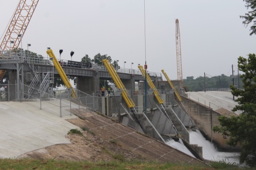 Three floodgates have been installed, and the hydraulic pressure unit, which will power the gates, is still awaiting delivery and installation. On top of rebuilding the floodgates, the new structure expands the width of the dam by 15 feet. (Amira Van Leeuwen/Community Impact)