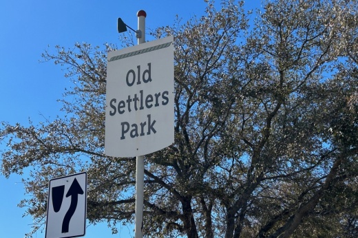 A sign at the Red Bud Lane entrance of Old Settlers Park