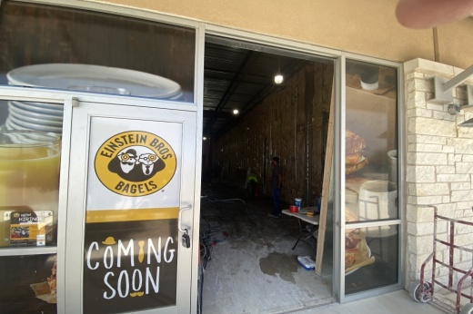 Coming soon sign on door of future Einstein Bros. Bagels location