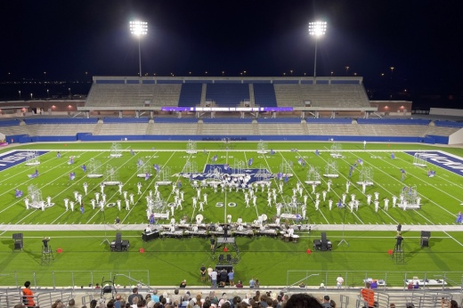 Marching band performing at Mckinney ISD stadium