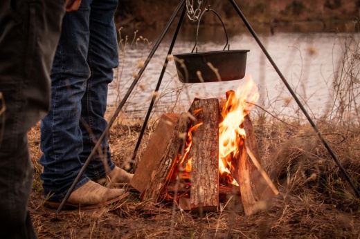 cowboy cooking over campfire