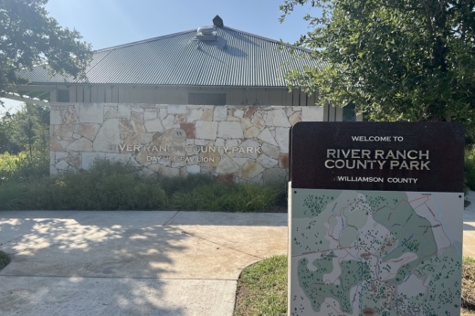 stone building with a sign in front that says river ranch county park