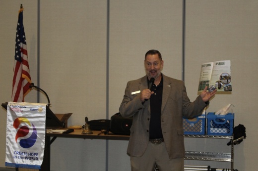 Picture of the Flower Mound Mayor holding an annual town report