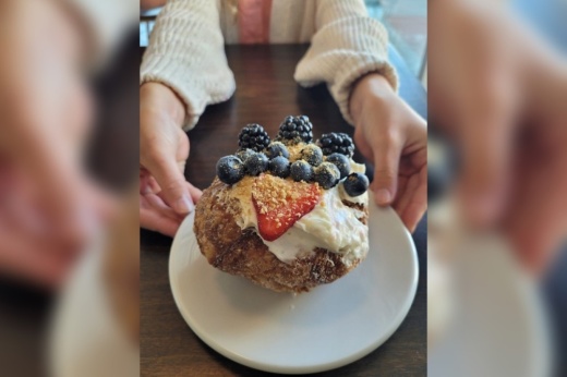 Doughnut on a plate being held