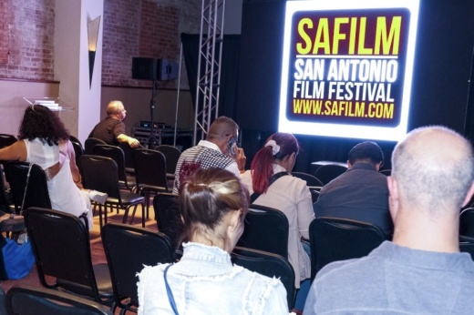 people sit in an audience at a film screening