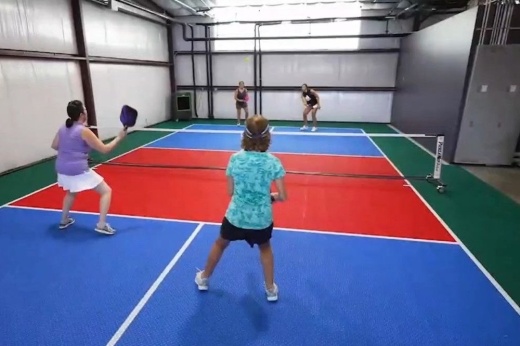 Four people play pickleball indoors at Last Stand Brewing Company..