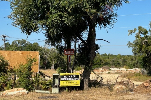 field with notice of public hearing sign