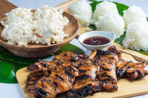 Close up of food with cooked meat, macaroni salad and rice