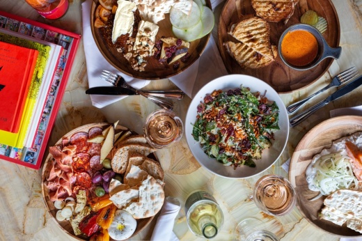 An assortment of plates and dishes of food in an overhead shot.