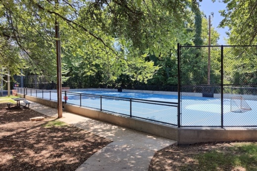 a blue court with fencing around it