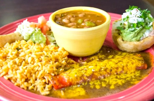 Plate of enchiladas, rice and beans