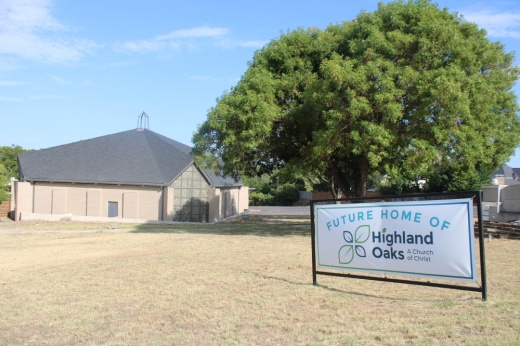 Highland Oaks banner and church in the background.