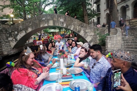 people dining on river boats on the San Antonio River
