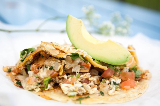 A migas taco with an avocado slice
