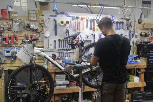 An employee of Blur Cycleworks repairs a bike