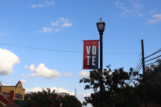A "vote" sign on a streetlamp