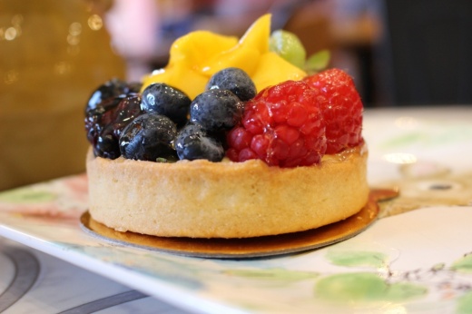 Fruit tart pastry on colorful plate at Delices de Maurice in Katy