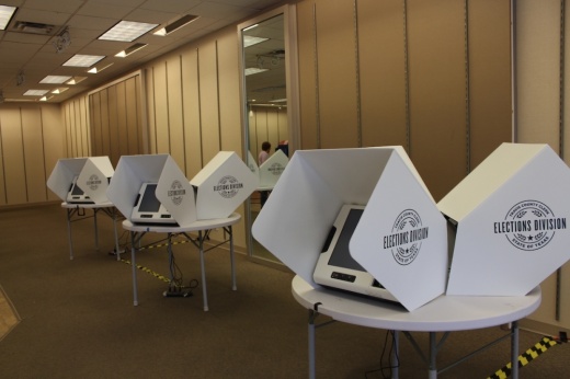 Three voting machines in a beige room