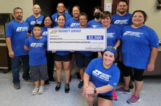 The Security Service Federal Credit Union Volunteer Corps presents a check to The Salvation Army on Aug. 10.