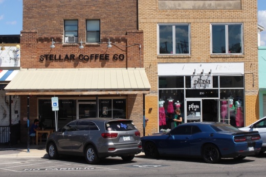 The exterior of a building with cars parked in front