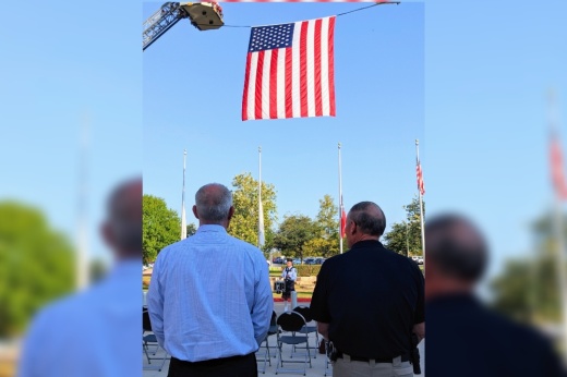 Live Oak staff in front of the American Flag.