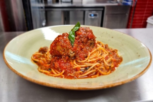 Spaghetti with homemade meatballs with marinara sauce and fresh basil, served on freshly prepared spaghetti with Sicilian extra-virgin olive oil