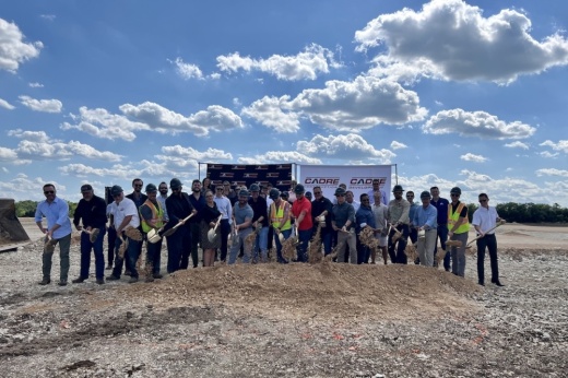 a group of people gather for a groundbreaking