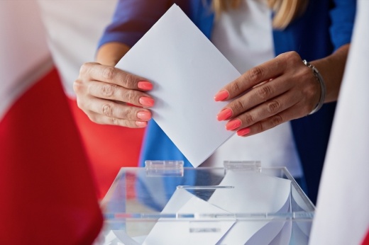 Woman casting paper ballot